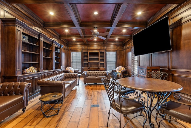 interior space featuring wooden ceiling, light wood-type flooring, wood walls, a ceiling fan, and ornamental molding