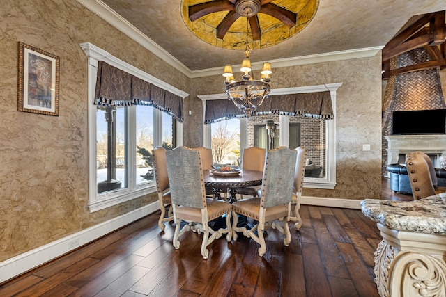 dining area with a chandelier, wood-type flooring, baseboards, and crown molding
