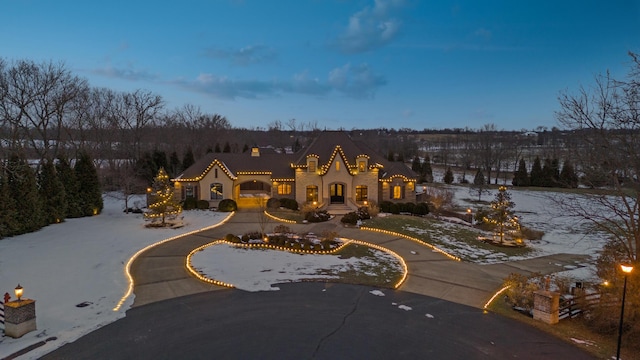 mediterranean / spanish house featuring curved driveway