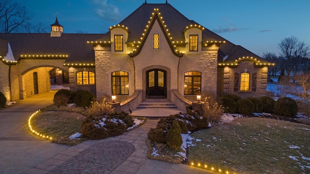view of front of home with brick siding and stone siding