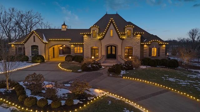 view of front of property featuring curved driveway and brick siding