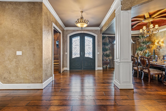 entryway featuring a chandelier, hardwood / wood-style floors, french doors, crown molding, and baseboards