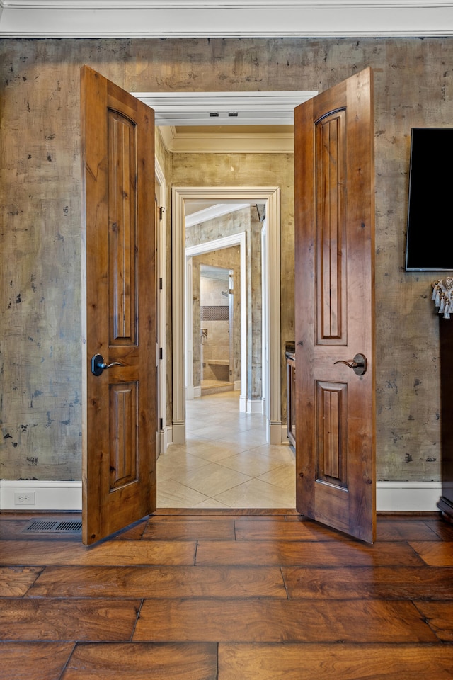 hallway with hardwood / wood-style flooring and crown molding