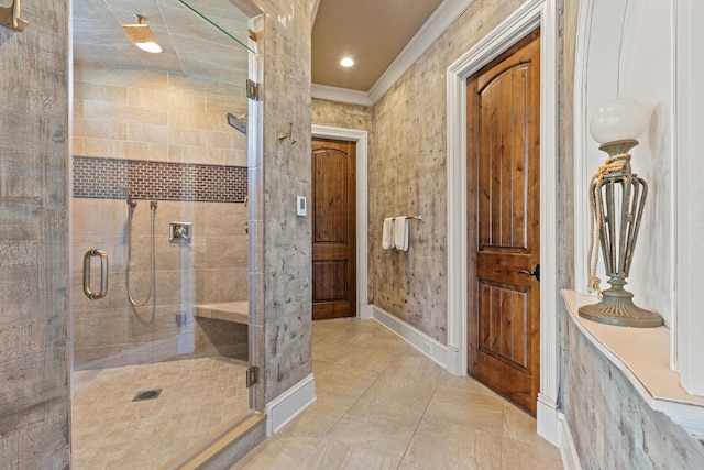 full bathroom with a stall shower, crown molding, tile patterned floors, and baseboards