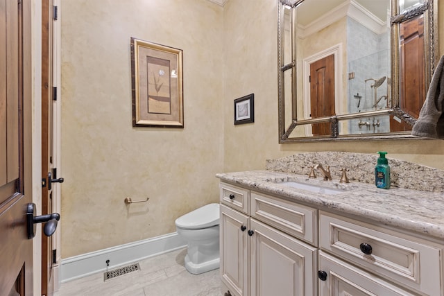 bathroom featuring ornamental molding, toilet, vanity, and baseboards