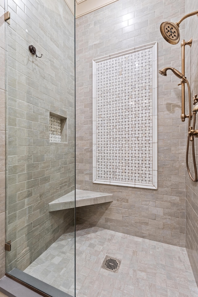 full bathroom with tiled shower