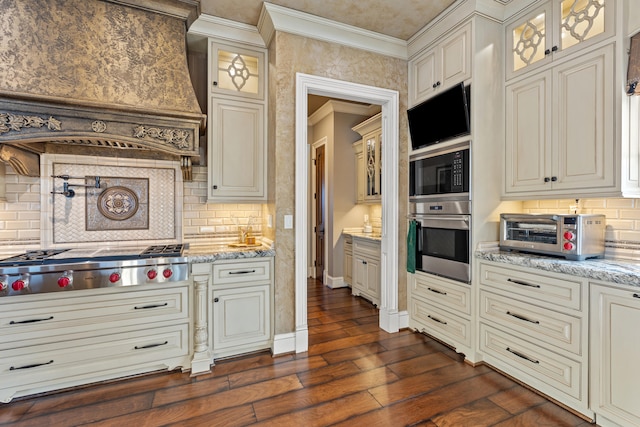 kitchen featuring stainless steel appliances, premium range hood, crown molding, backsplash, and dark wood-style floors