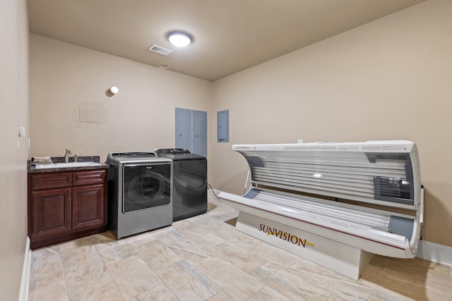 laundry room with cabinet space, washing machine and clothes dryer, a tanning bed, electric panel, and baseboards