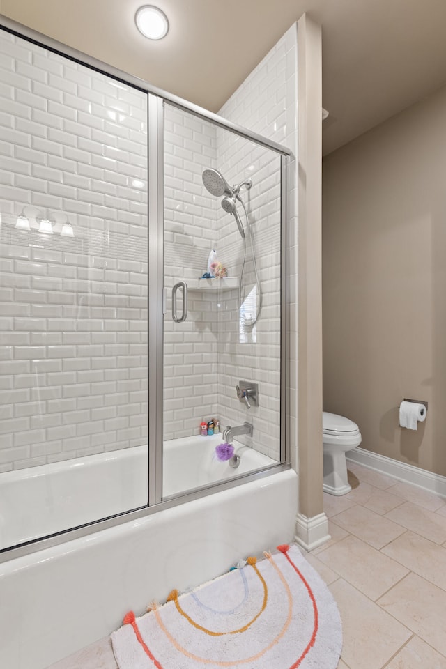 bathroom featuring tile patterned floors, combined bath / shower with glass door, toilet, and baseboards