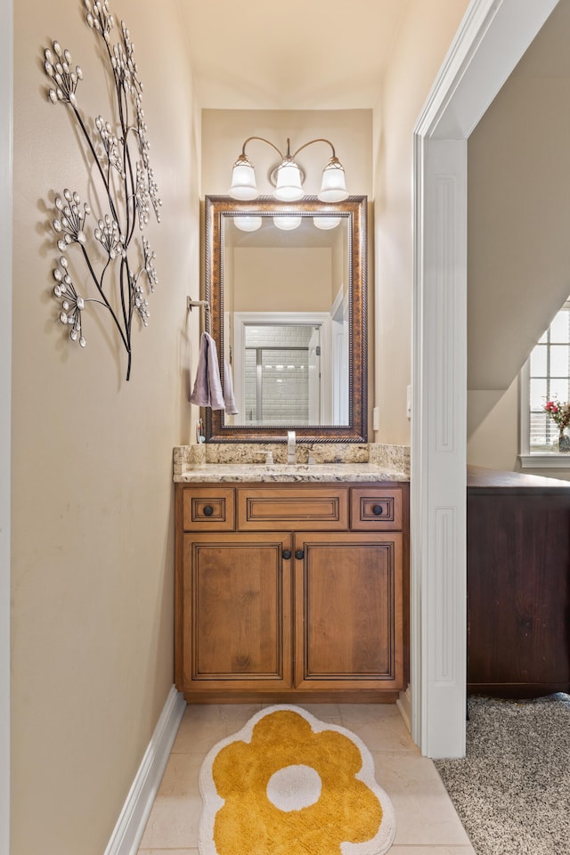 bathroom featuring vanity and baseboards