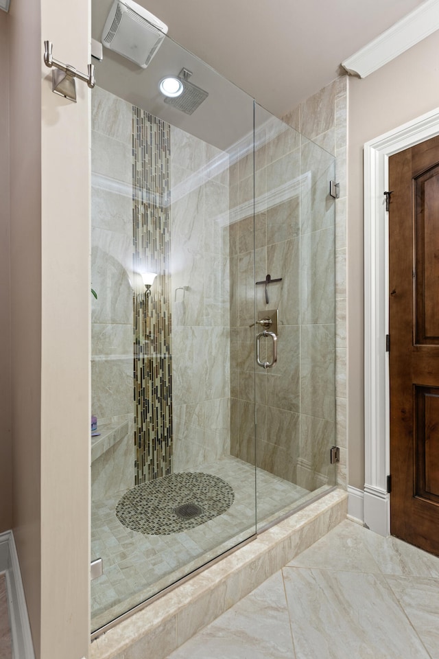 bathroom with a stall shower and marble finish floors