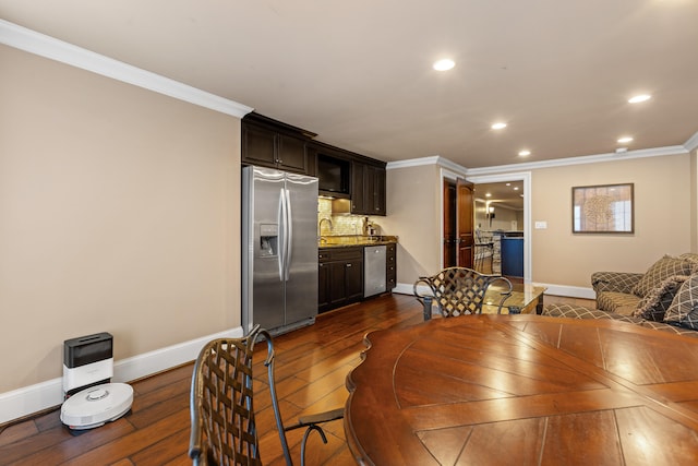 dining room featuring ornamental molding, baseboards, dark wood finished floors, and recessed lighting
