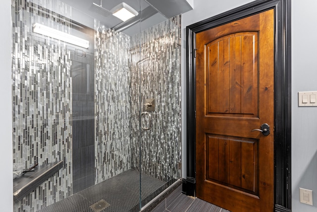 full bath featuring a tile shower and tile patterned floors