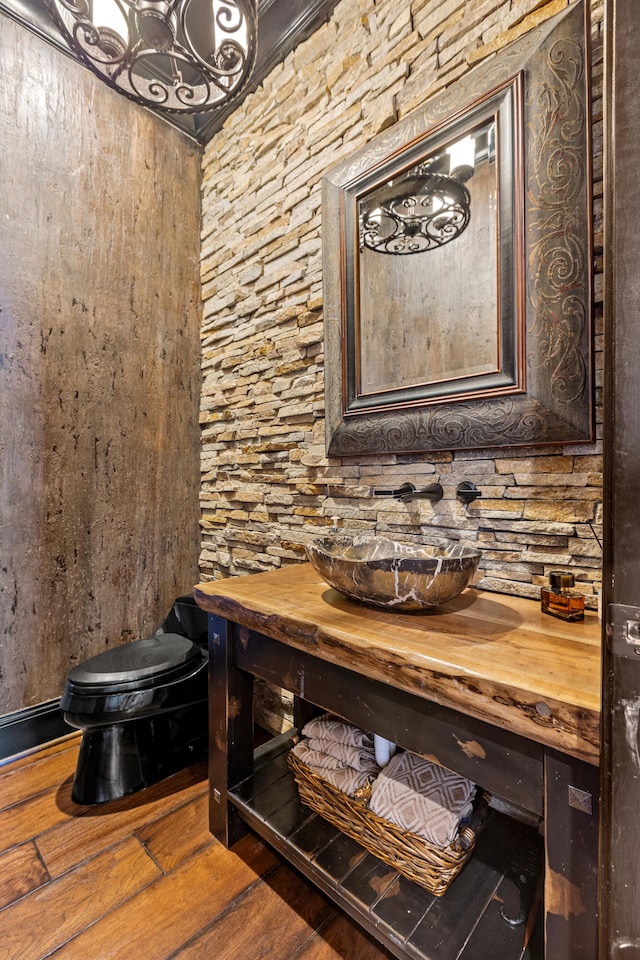 detailed view of wood finished floors and a chandelier