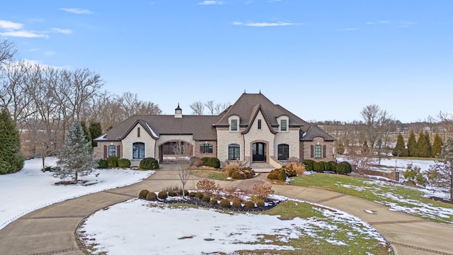 french country inspired facade with stone siding