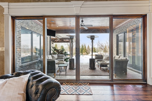doorway to outside featuring ceiling fan and wood finished floors