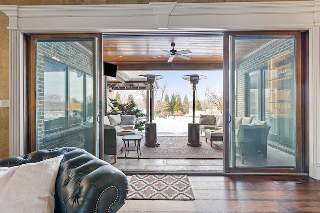 doorway featuring ceiling fan and wood finished floors