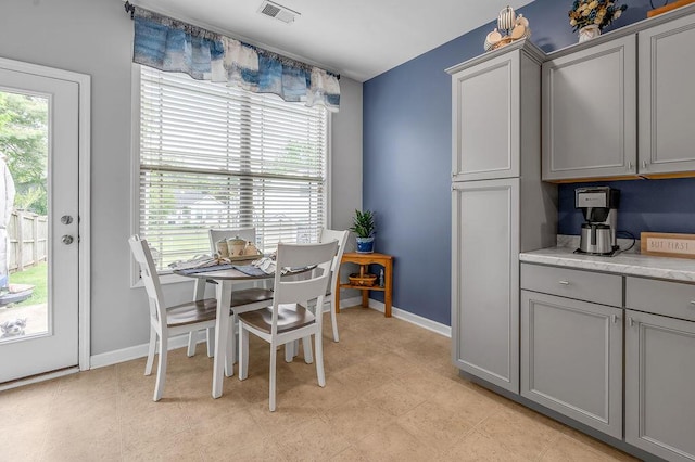 dining space featuring plenty of natural light and baseboards