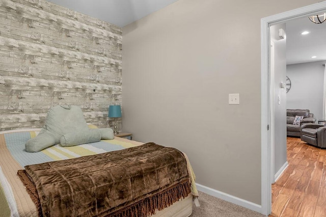 bedroom with baseboards, recessed lighting, and wood finished floors