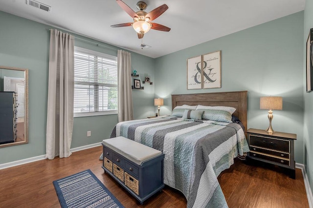 bedroom featuring baseboards, wood finished floors, and ceiling fan