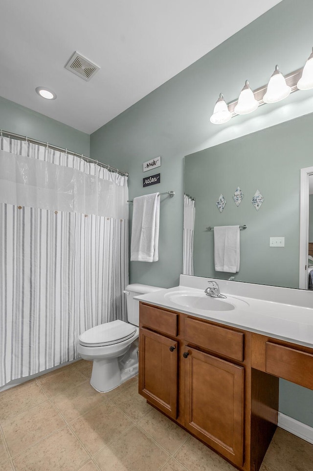 bathroom featuring vanity, toilet, and tile patterned floors