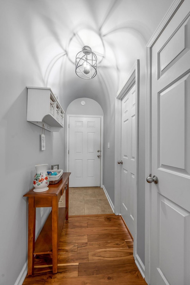 hallway with light wood finished floors and baseboards