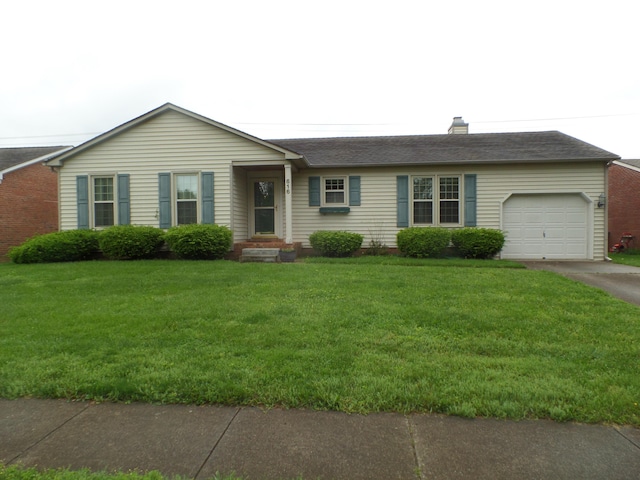 single story home with an attached garage, driveway, a front yard, and a chimney