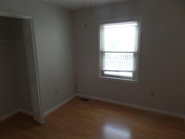 unfurnished bedroom with light wood finished floors and baseboards