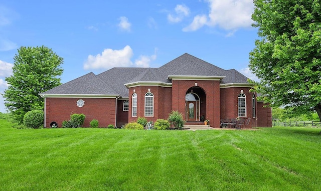 view of front of home featuring brick siding and a shingled roof