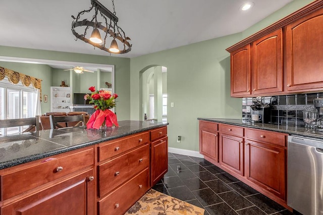 kitchen with dishwasher, arched walkways, baseboards, recessed lighting, and tasteful backsplash