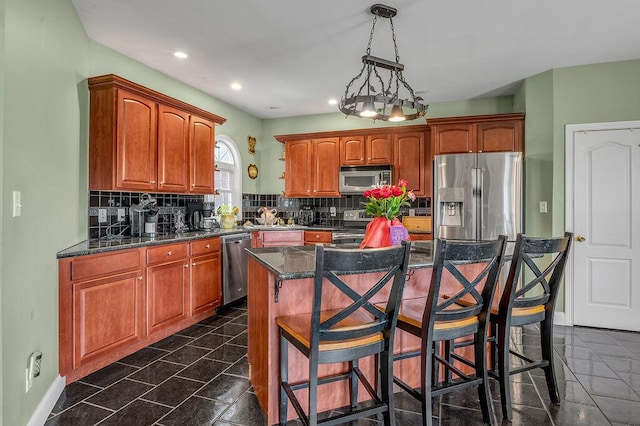 kitchen featuring stainless steel appliances, decorative backsplash, a kitchen breakfast bar, recessed lighting, and a kitchen island