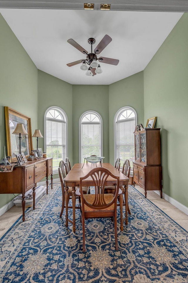 dining space featuring baseboards and a ceiling fan