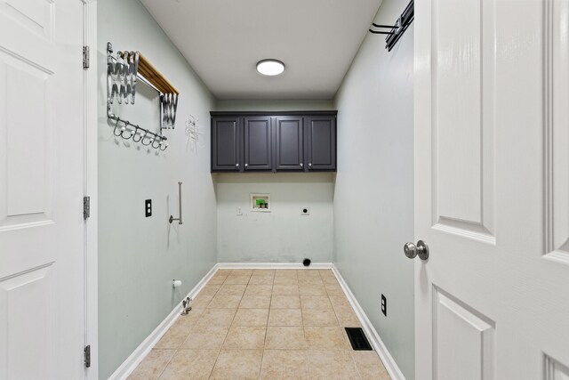 laundry room with hookup for an electric dryer, hookup for a washing machine, cabinet space, hookup for a gas dryer, and light tile patterned floors