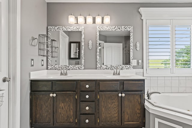 full bath featuring double vanity and a bath
