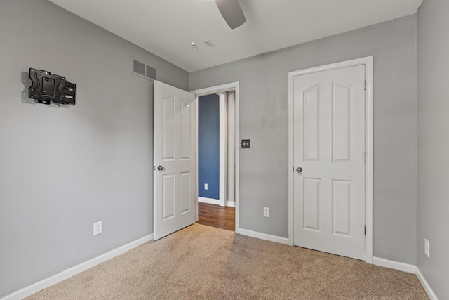 unfurnished bedroom featuring carpet flooring, baseboards, and ceiling fan