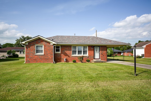 view of front of property featuring driveway, a front yard, brick siding, an attached carport, and roof with shingles
