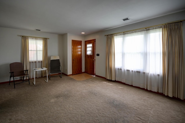 carpeted foyer entrance with plenty of natural light, baseboards, and recessed lighting