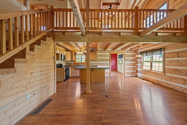1648 Burdette Knob Rd, Lancaster, KY 40444 - kitchen with electric range, wood finished floors, stainless steel microwave, beam ceiling, and wooden walls
