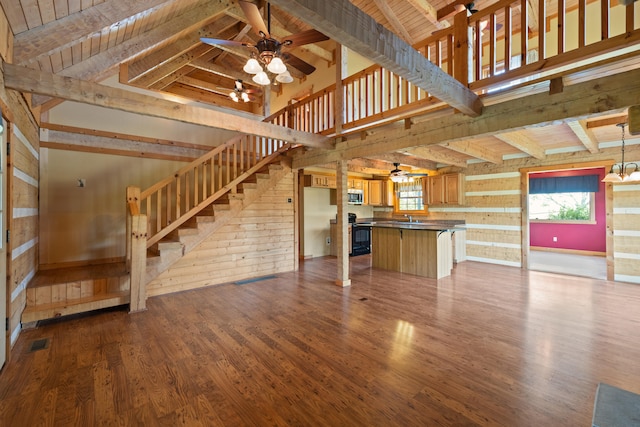 1648 Burdette Knob Rd, Lancaster, KY 40444 - unfurnished living room with ceiling fan, dark wood finished floors, plenty of natural light, beam ceiling, and wooden walls