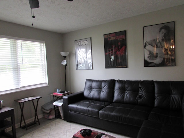 324 Spruce Dr, Frankfort, KY 40601 - living area featuring a textured ceiling, a ceiling fan, baseboards, and tile patterned flooring