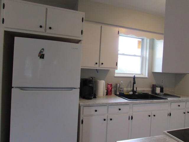 324 Spruce Dr, Frankfort, KY 40601 - kitchen with freestanding refrigerator, a sink, white cabinetry, and light countertops