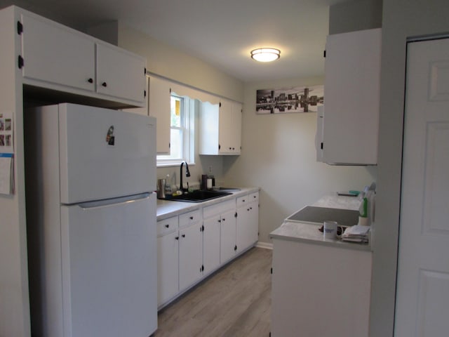 324 Spruce Dr, Frankfort, KY 40601 - kitchen with freestanding refrigerator, a sink, light wood finished floors, white cabinets, and light countertops