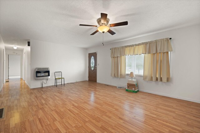 279 Hatton Creek Rd, Stanton, KY 40380 - unfurnished living room with heating unit, ceiling fan, wood finished floors, and a textured ceiling