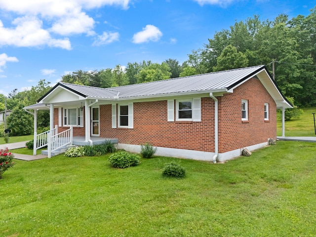 279 Hatton Creek Rd, Stanton, KY 40380 - ranch-style house featuring a porch, brick siding, metal roof, and a front lawn