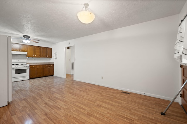 279 Hatton Creek Rd, Stanton, KY 40380 - unfurnished living room featuring light wood finished floors, a textured ceiling, baseboards, and ceiling fan