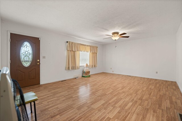 279 Hatton Creek Rd, Stanton, KY 40380 - entrance foyer featuring light wood-style floors, ceiling fan, baseboards, and a textured ceiling