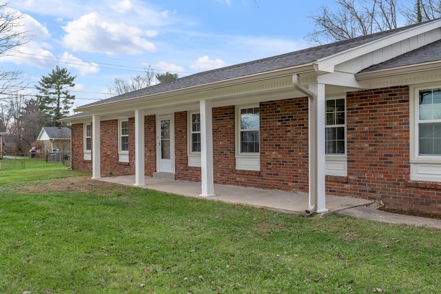 1303 Chinook Trl, Frankfort, KY 40601 - rear view of property featuring brick siding, a lawn, and a shingled roof