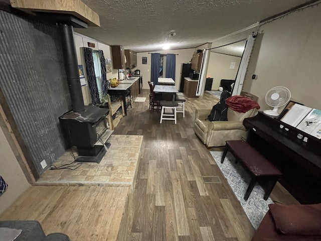 living area featuring dark wood-type flooring and a textured ceiling