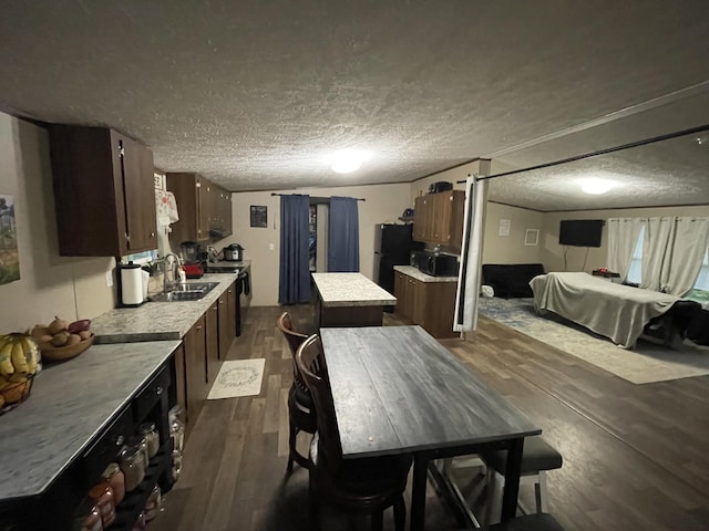 dining space featuring dark wood-style floors and a textured ceiling