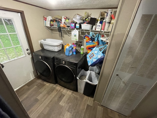 clothes washing area featuring independent washer and dryer, wood finished floors, a heating unit, and a textured ceiling